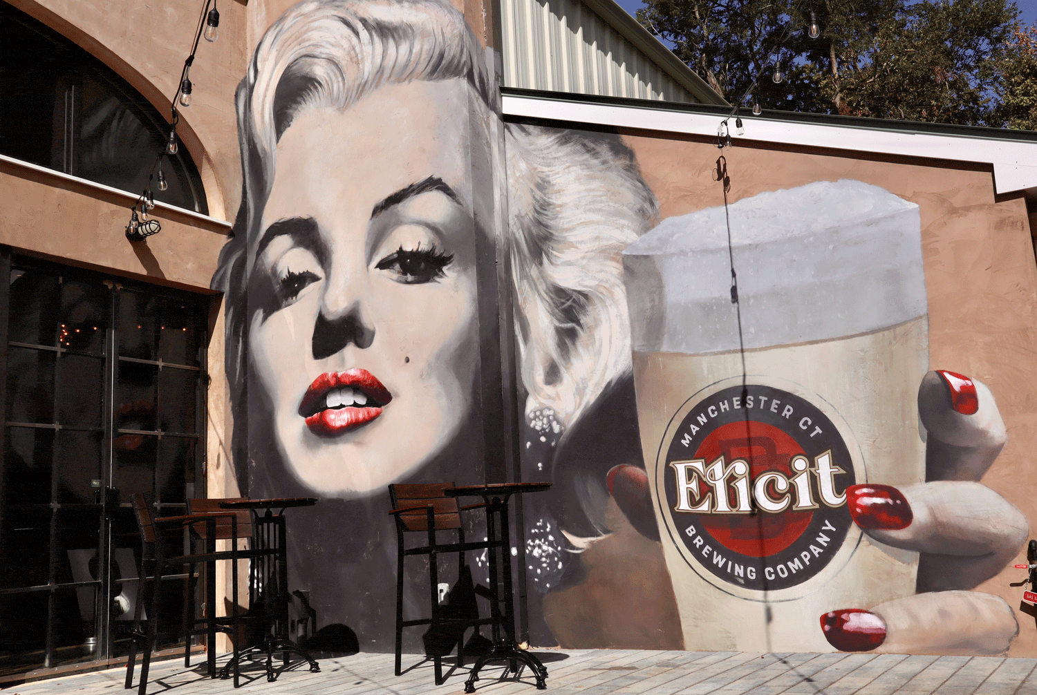 Hand-painted Marilyn Monroe and Elicit Brewing mural on the Manchester patio