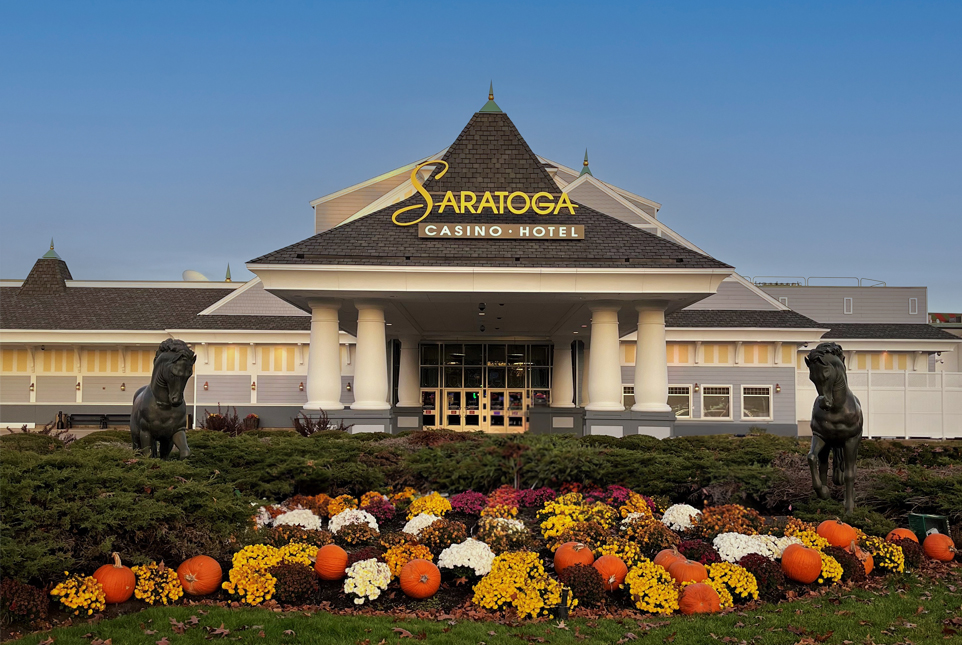 a building with a flower bed and a statue of a lion